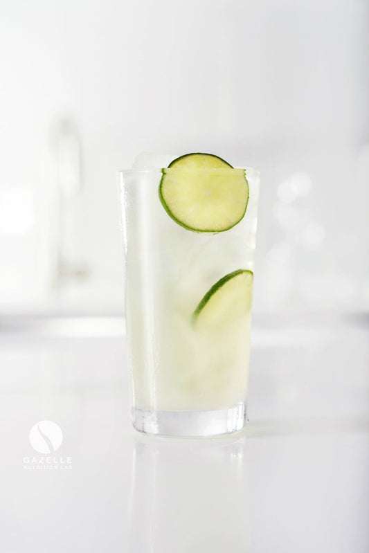Picture of a clear glass of sports drink illustrating the need for hydration for Fuel Kit customers.