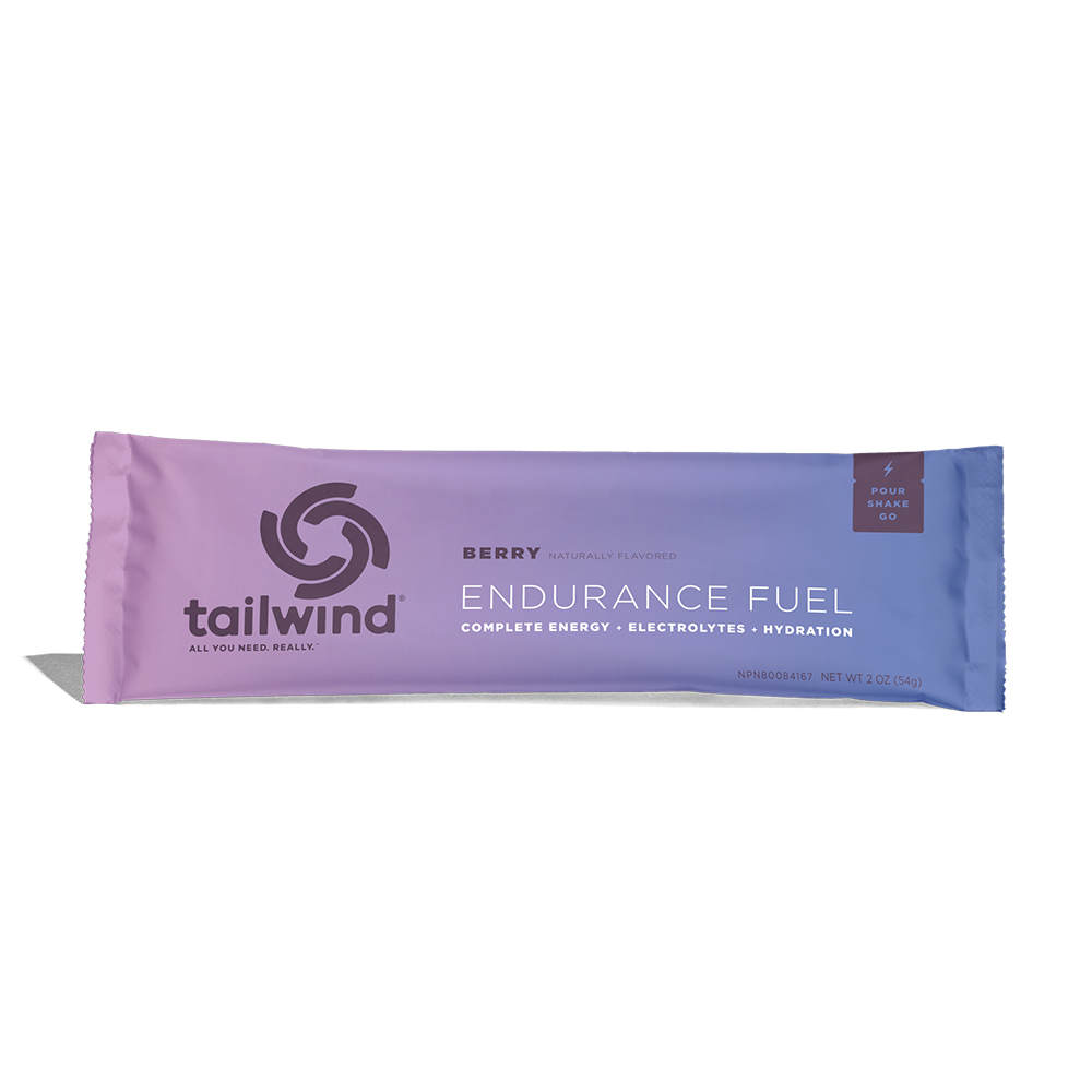 A packet of Tailwind Endurance Fuel labeled 'Berry' with a purple and white design, indicating it is a caffeine-free sports nutrition drink mix.