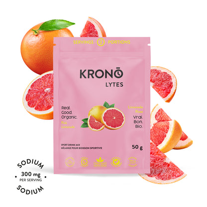 A packet of Krono Nutrition Krono Lytes with pink lemons around it. The packet indicates the product is organic, vegan, and provides a sodium content of 300 mg per serving.