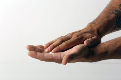 Close-up of a person's hands rubbing in FrictionLabs Liquid Chalk before HYROX or lifting, available at Fuel Kit.