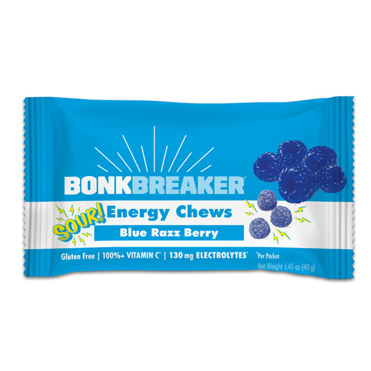 A packet of Bonk Breaker Energy Chews with Blue Razz Berry flavor, highlighting gluten-free, 100% vitamin C, and 130 mg electrolytes on the package.