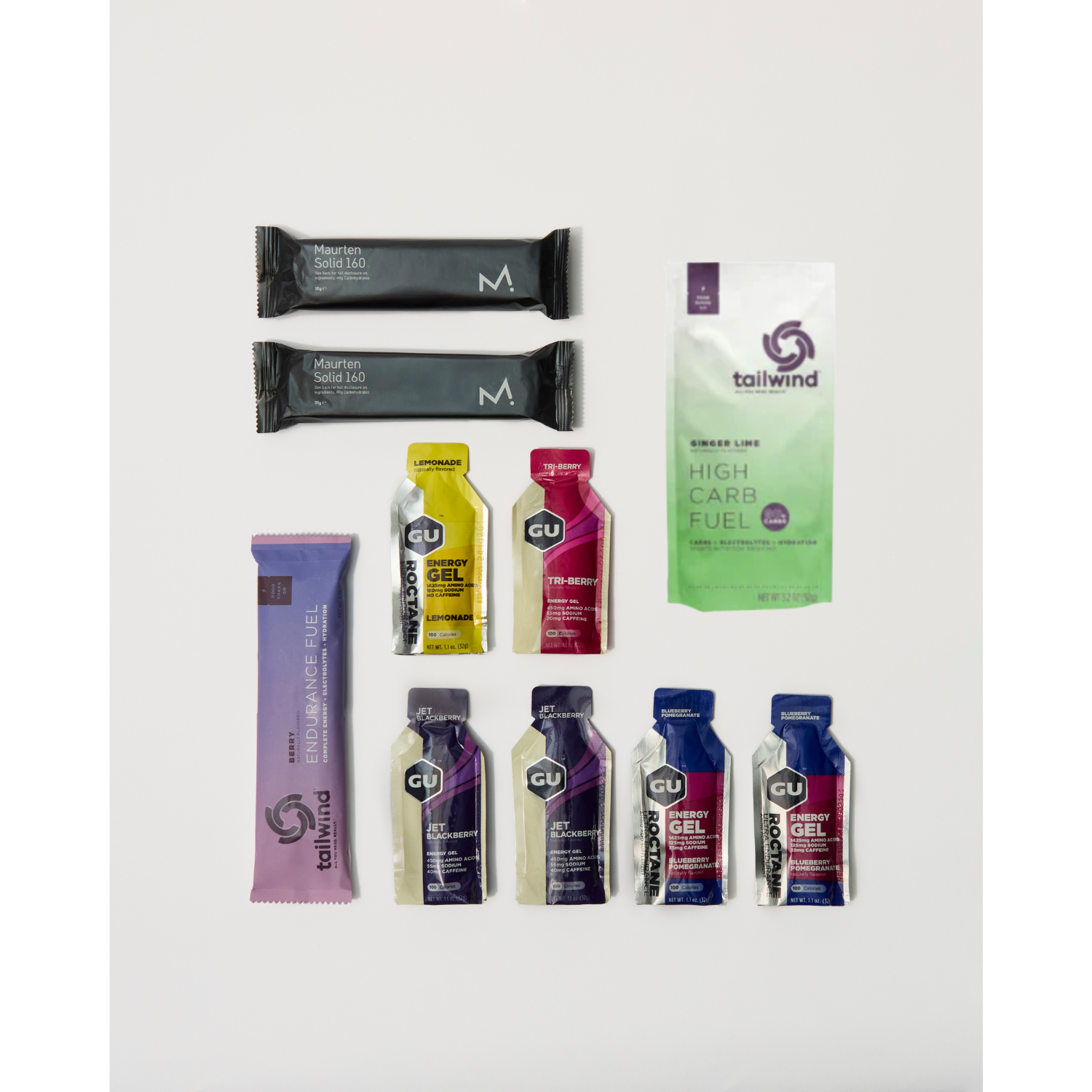 Collection of sports nutrition products including gels and bars on a white background