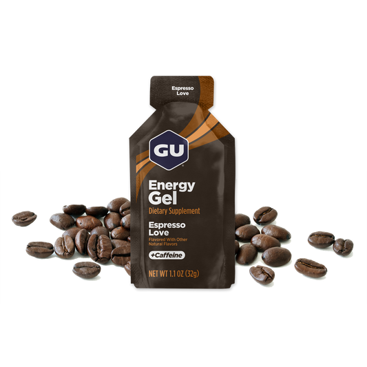 A packet of GU Energy Gel with the flavour Espresso Love  highlighted, containing 40 mg Caffeine, with images of coffee beans in the background.