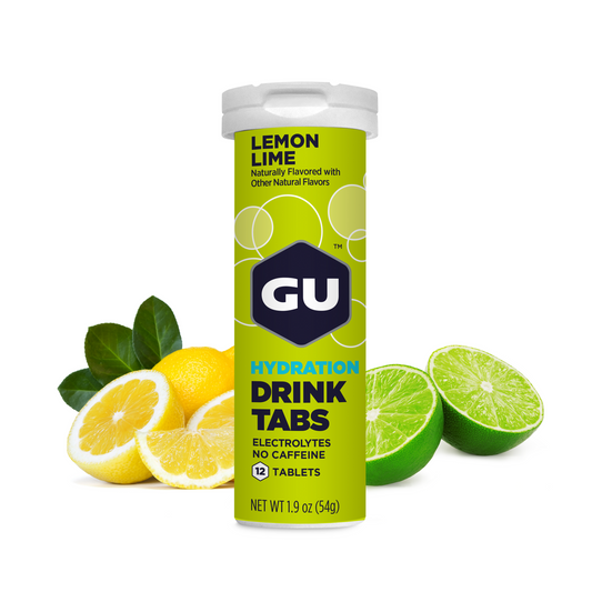 A tube of GU Hydration Drink Tabs with lemon and lime depicted around it, indicating the flavor of the product.