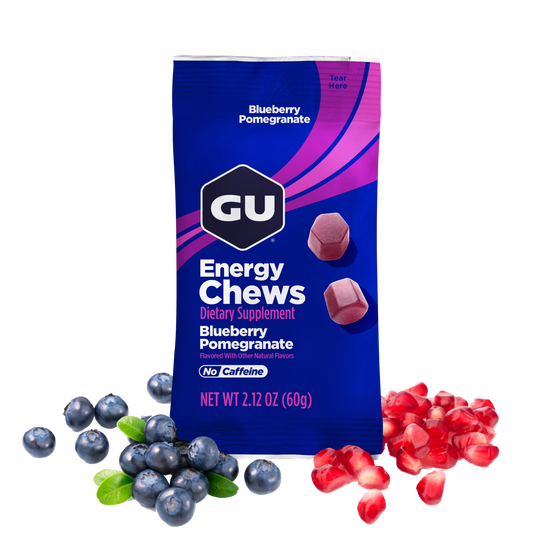 GU Energy Chews package with blueberries and pomegranate seeds on a white background