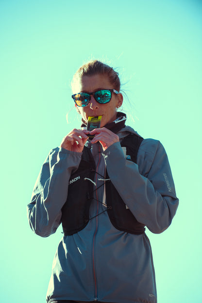 Courtney Dauwalter eating a Näak Boost  Ice Mint gel packet available at Fuel Kit
