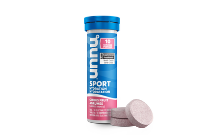 Nuun Citrus Fruit Supplement tube with pink tablets on a white background with three tablets