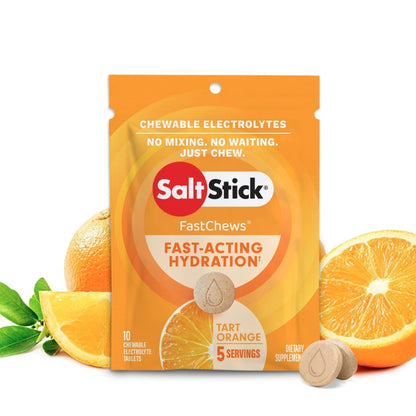 A packet of SaltStick FastChews with orange flavor, featuring the product's name and benefits, surrounded by images of oranges.