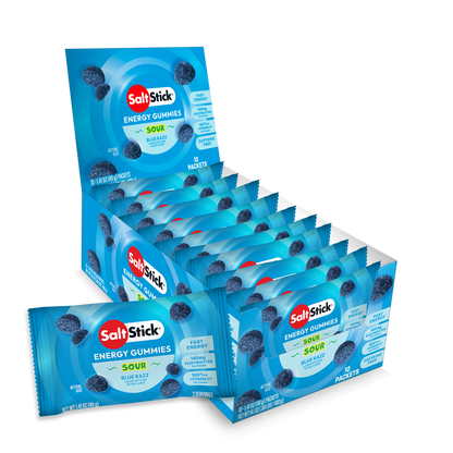A retail display box and individual packets of SaltsStick Energy Gummies in Sour Blue Razz available at Fuel Kit