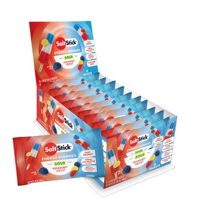 A display box and individual packets of SaltsStick Energy Gummies Sour Pop Rocket flavor, available at Fuel Kit.