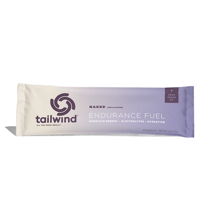 A packet of Tailwind Endurance Fuel labeled 'Naked' with a purple and white design, indicating it is a caffeine-free sports nutrition drink mix.