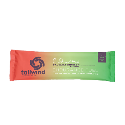 A packet of Tailwind Endurance Fuel labeled 'Dauwaltermelon' with a orange and green design, indicating it is a caffeine-free sports nutrition drink mix.