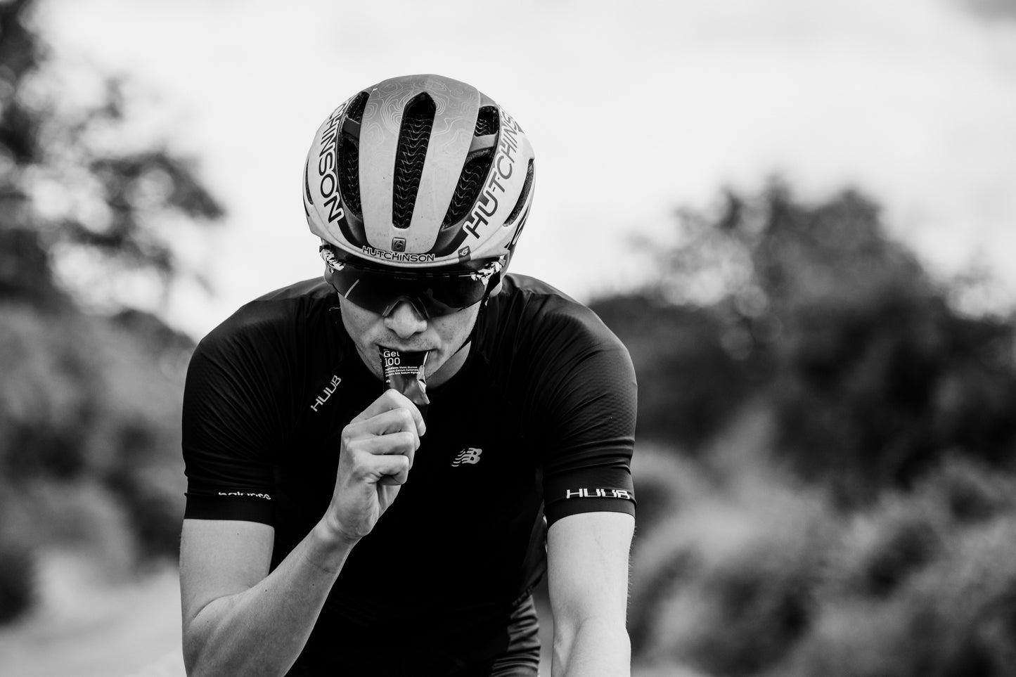 Male cyclist taking a Maurten Gel 100
