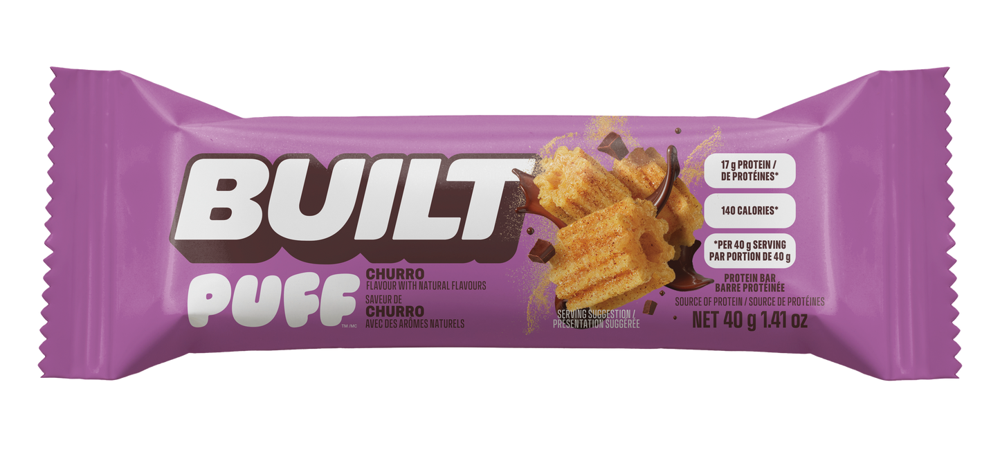 A purple wrapper for a Built Puff Churro protein bar, available at Fuel Kit.