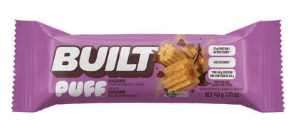 A purple wrapper for a Built Puff Churro protein bar, available at Fuel Kit.