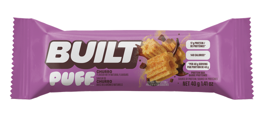 A purple wrapper for a Built Puff Churro protein bar, available at Fuel Kit.