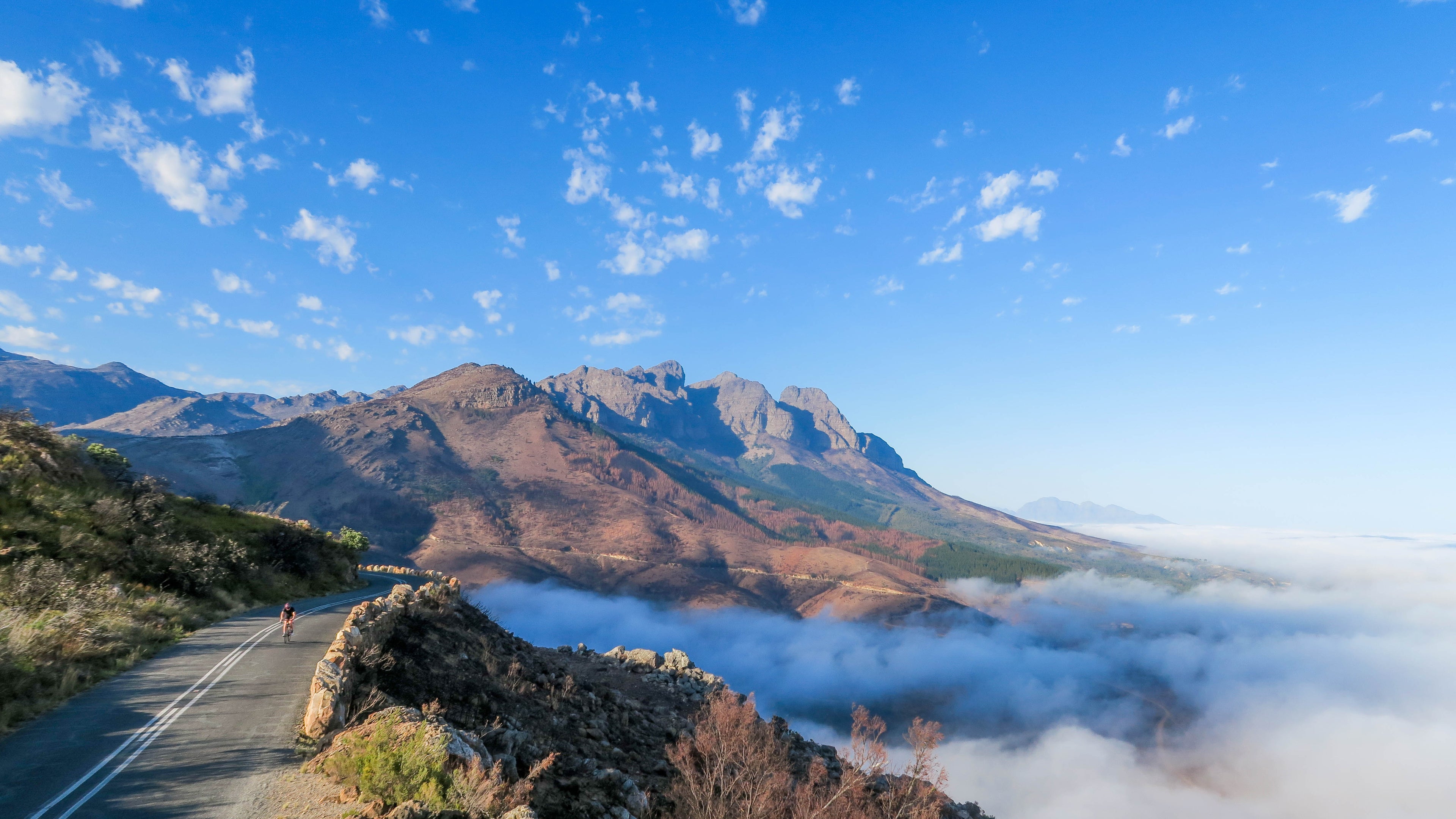 Mountainous landscape with a clear blue sky and road