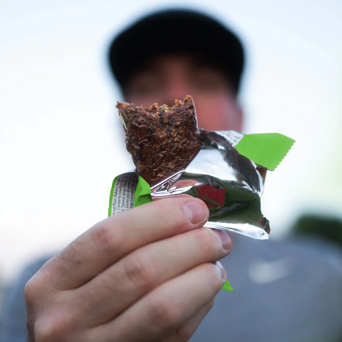 Runner in a cap holding a Krono Apple & Maple Bar | Fuel Kit